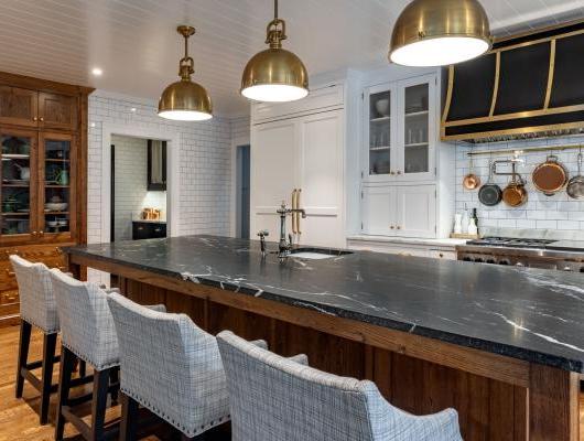 modern kitchen with big island and white tile on the walls